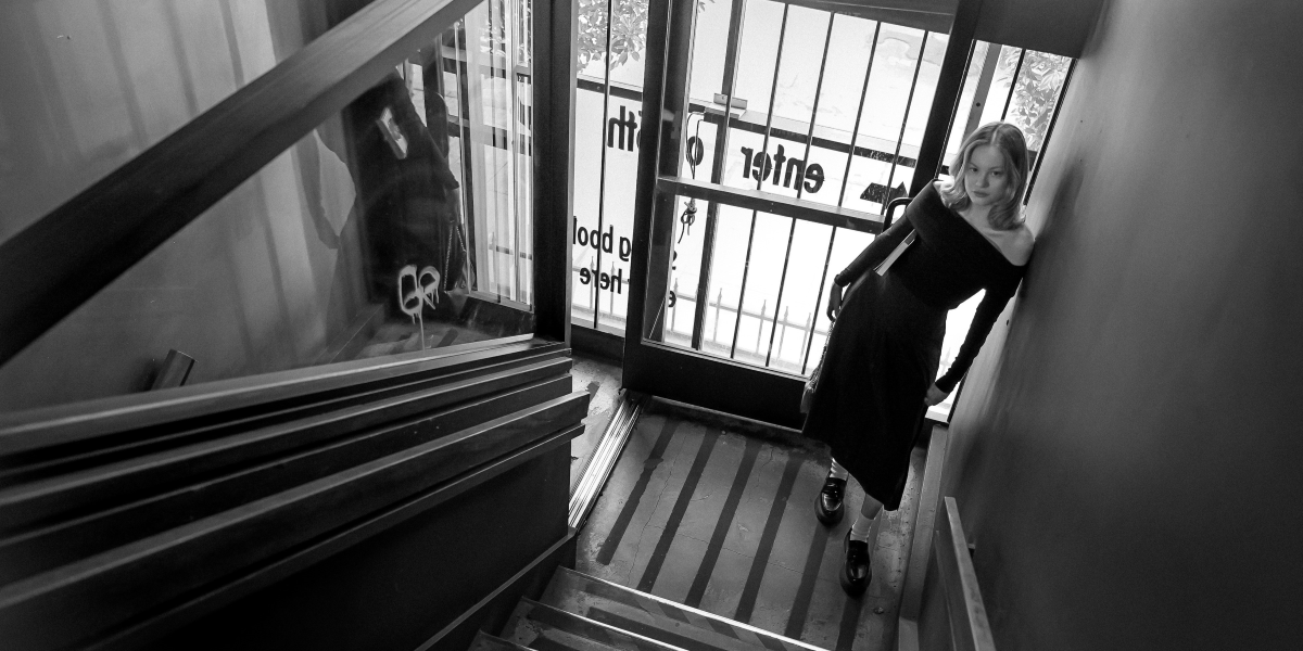 woman standing near a staircase